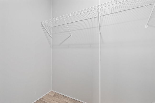 Walk in closet featuring light wood-style flooring | Image 8