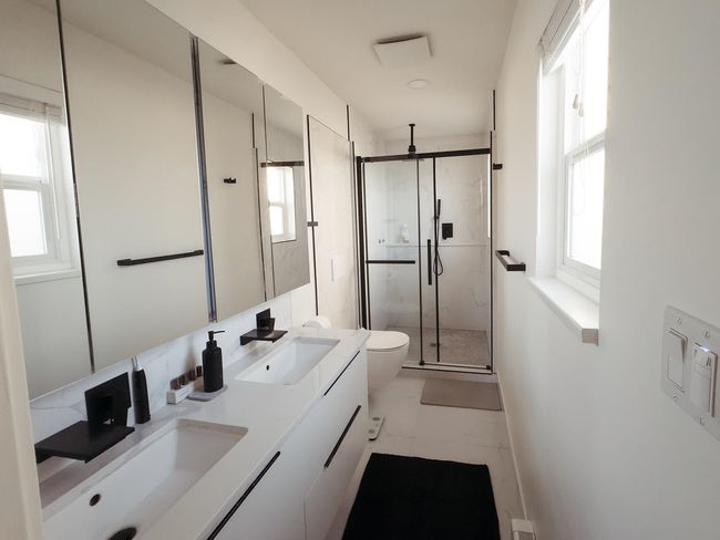 Bathroom with marble finish floors, double vanity, a marble finish shower, and toilet | Image 20
