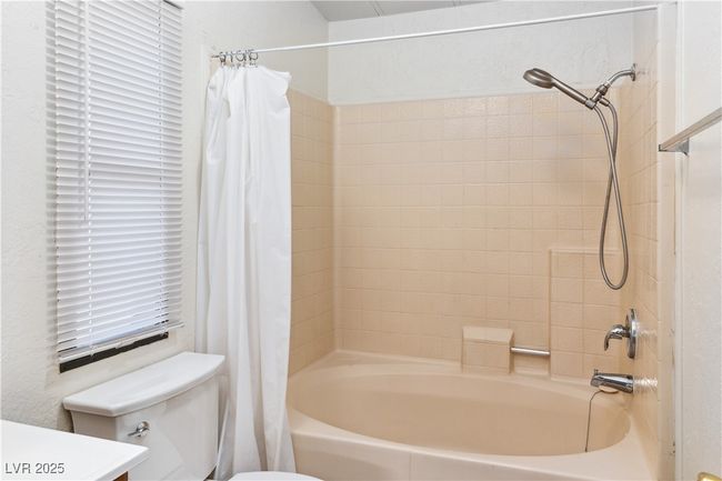 Full bath featuring shower / tub combo with curtain, vanity, and toilet | Image 24