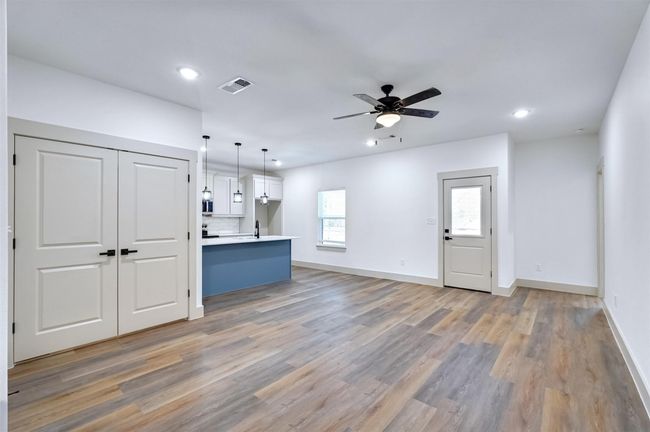 Unfurnished living room featuring baseboards, recessed lighting, a ceiling fan, light wood-style floors, and visible vents | Image 8