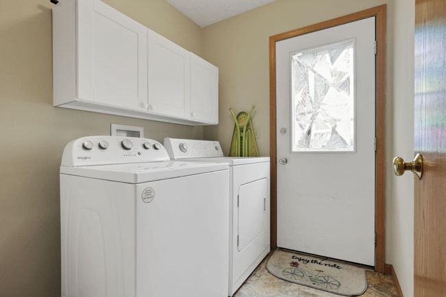 First floor laundry and door that leads to the patio | Image 21