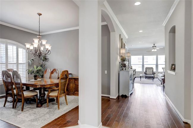 Engineered hardwood floors welcome you into the main common areas of the home from the tiled hallway. | Image 10