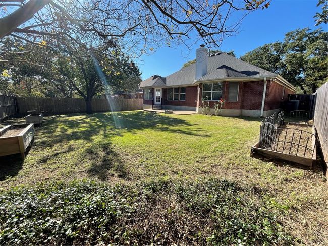 Fenced backyard with a vegetable garden and a patio | Image 32