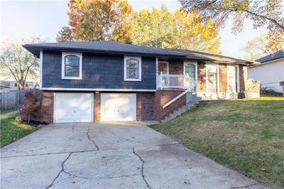 View of front of house featuring a front lawn and a garage | Image 1