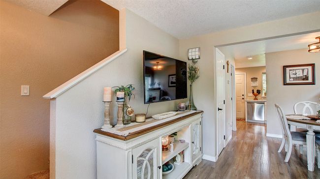 Hallway with wood finished floors and a textured ceiling | Image 14