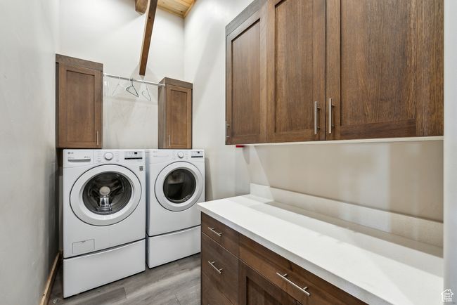 Laundry area with separate washer and dryer, cabinet space, and light wood finished floors | Image 36