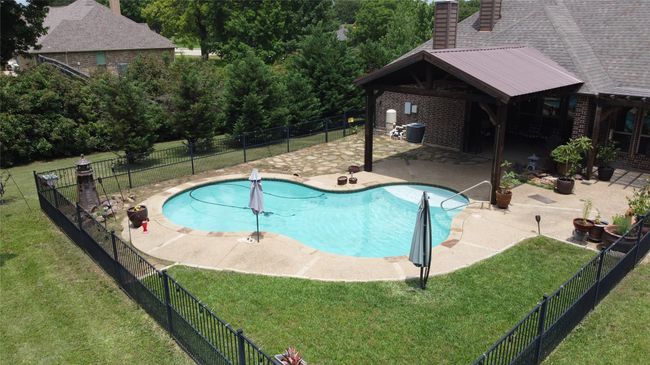 View of swimming pool with a patio and cooling unit | Image 37