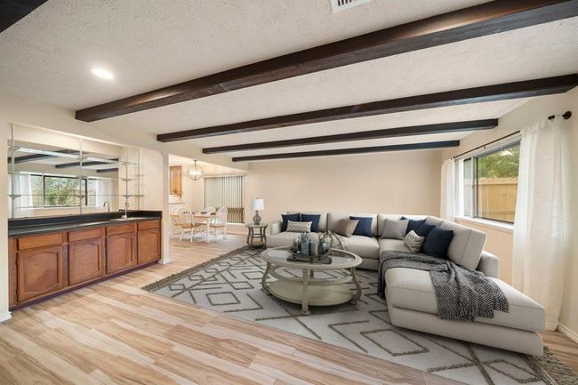 Oversized windows provide abundant natural light, while the open layout connects seamlessly to the breakfast area and kitchen for optimal flow. This photo has been virtually staged. | Image 17