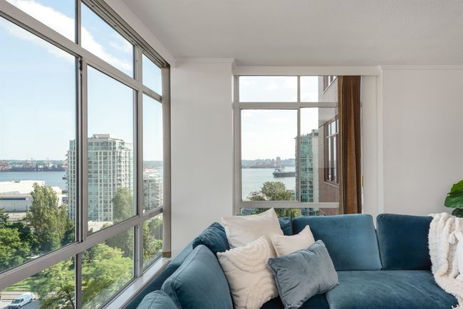 Living area with a water view, a view of city, and crown molding | Image 8