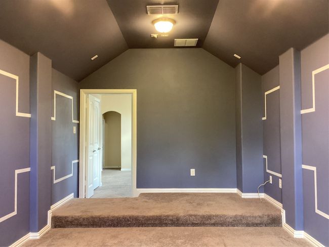 Carpeted empty room with vaulted ceiling, arched walkways, and baseboards | Image 27