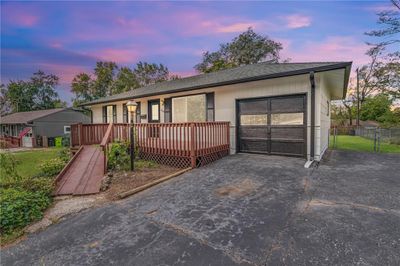 View of front of home with a wooden deck | Image 3