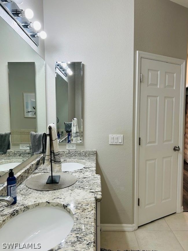 Bathroom with tile floors and dual bowl vanity | Image 20