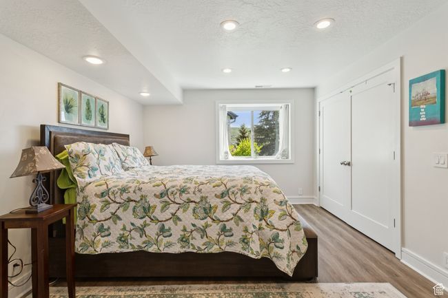 Bedroom with wood finished floors and recessed lighting | Image 31