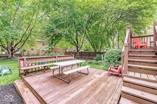 wooden terrace with a fenced backyard and outdoor dining space | Image 27