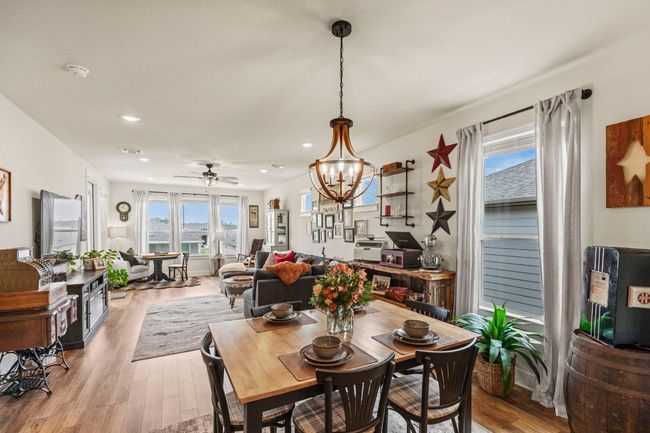 Dining area with recessed lighting, light wood-style floors, and ceiling fan with notable chandelier | Image 14