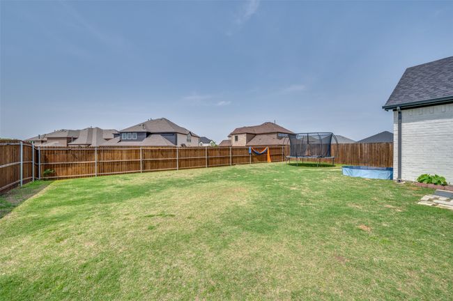 View of yard featuring a fenced backyard and a trampoline | Image 36