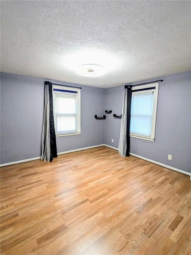 Spare room with a textured ceiling and light wood finished floors | Image 11