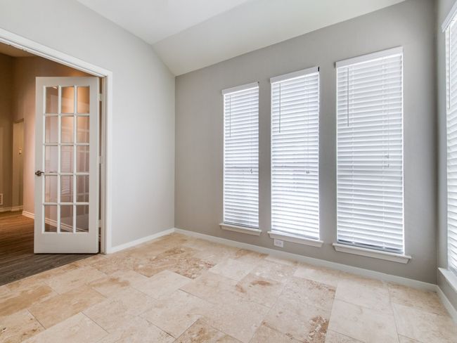 Unfurnished room with lofted ceiling, baseboards, and stone finish flooring | Image 9