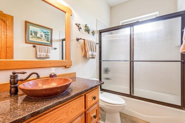 Bathroom with vanity, enclosed tub / shower combo, and toilet | Image 24