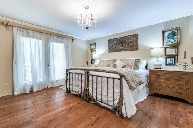 Bedroom with crown molding, a chandelier, and hardwood / wood-style flooring | Image 18