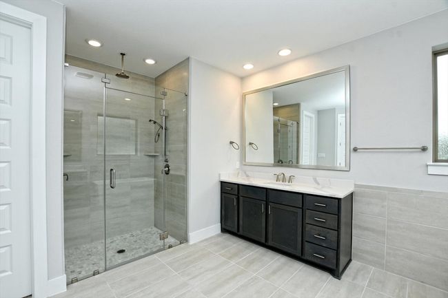 Bathroom featuring tile patterned floors, vanity, a stall shower, and recessed lighting | Image 20