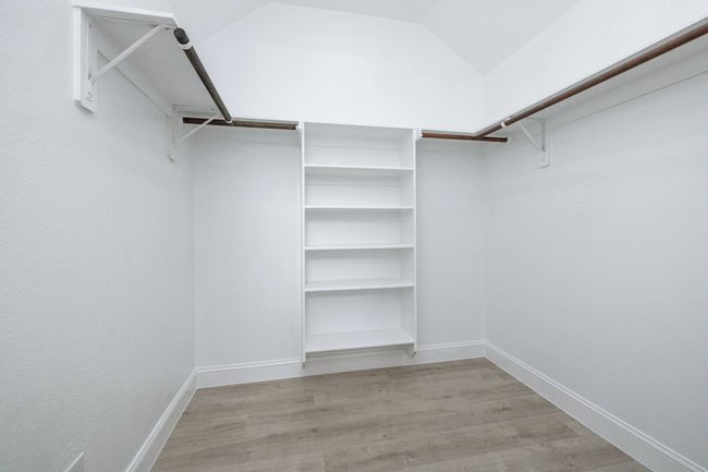 Walk in closet featuring light wood-style floors | Image 33
