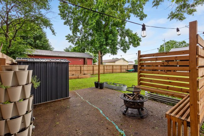This patio at the rear of the backyard makes for a perfect fire pit area. Owners have added lots of outside storage both here and next to the back patio. | Image 8