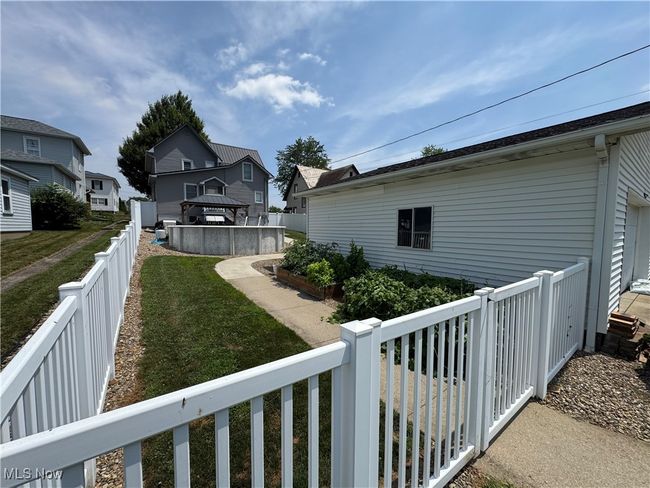 Fenced backyard featuring a residential view and a gazebo | Image 34