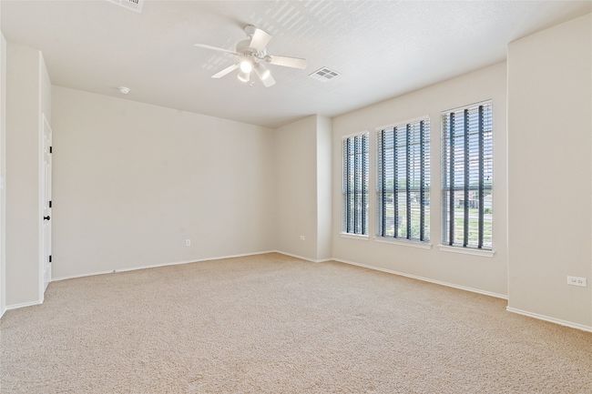 Spare room with a ceiling fan, carpet floors, baseboards, and visible vents | Image 21