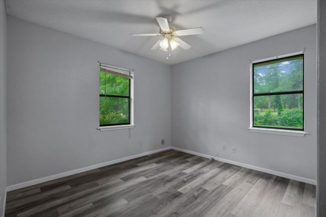 Unfurnished room featuring wood finished floors and a ceiling fan | Image 10