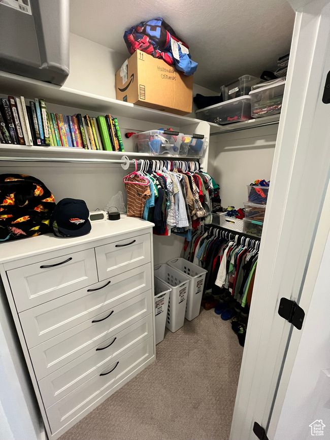 Walk in closet featuring carpet | Image 27