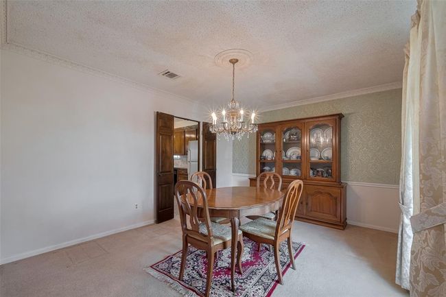 Elegant dining room seamlessly connected to the kitchen. | Image 6
