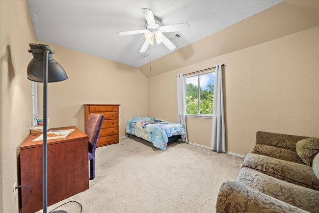 Carpeted bedroom with lofted ceiling, a ceiling fan, and baseboards | Image 32