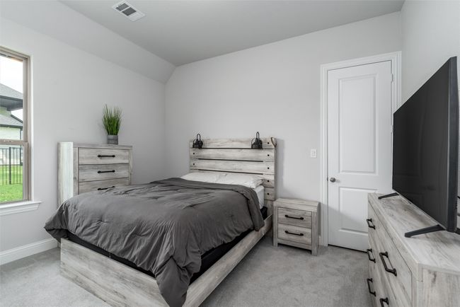Bedroom featuring light carpet, vaulted ceiling, and baseboards | Image 22
