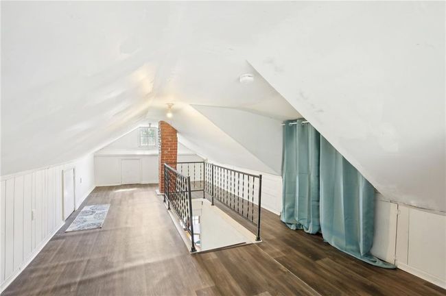 Additional living space featuring lofted ceiling and wood finished floors | Image 20
