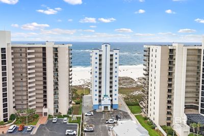 View of building exterior with a water view and a view of the beach | Image 2