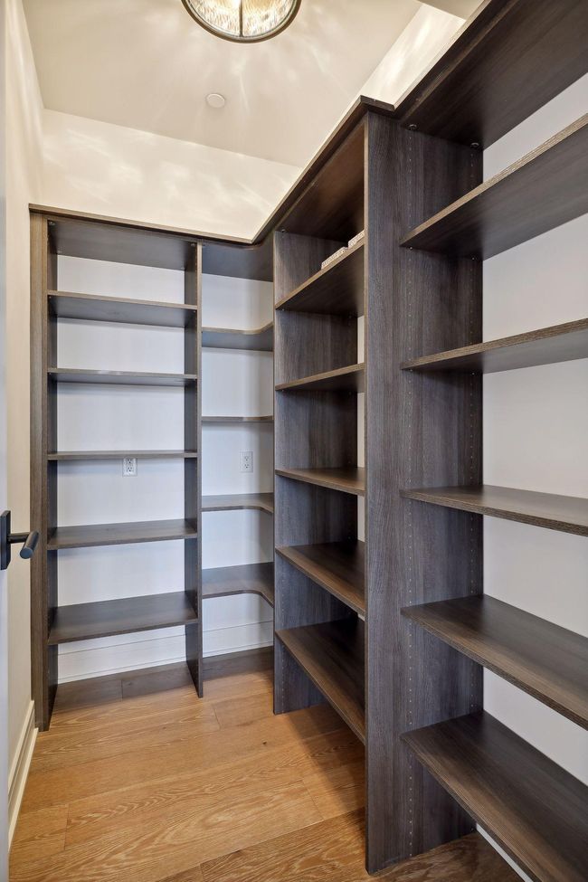 Kitchen space includes a walk-in pantry with built-in organizational components | Image 13