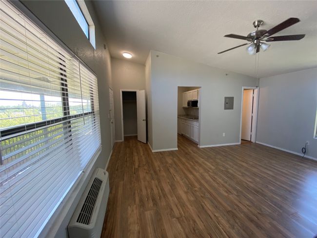This huge living area has easy access to each and every other room. Notice the new flooring and large windows. | Image 4