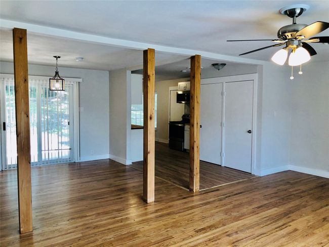 Unfurnished living room featuring wood finished floors and a ceiling fan | Image 4