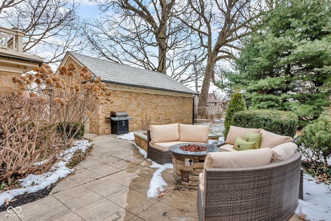 view of patio / terrace featuring an outdoor structure, grilling area, fence, and an outdoor living space with a fire pit | Image 27