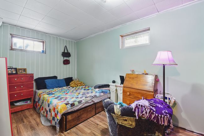 Bedroom featuring multiple windows, wood finished floors, and ornamental molding | Image 25