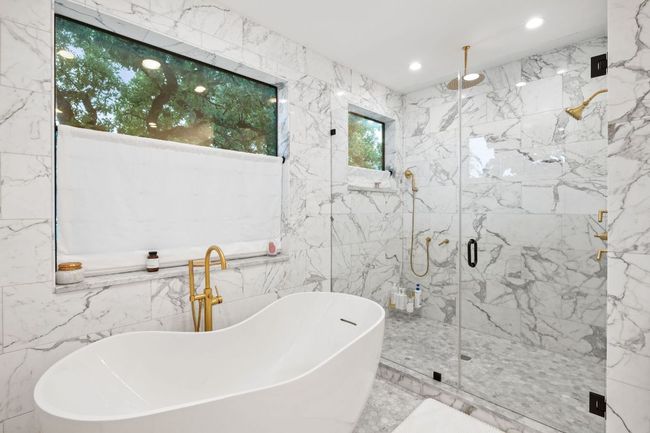 Full bathroom with tile walls, a marble finish shower, marble tiled flooring, a soaking tub, and recessed lighting | Image 27