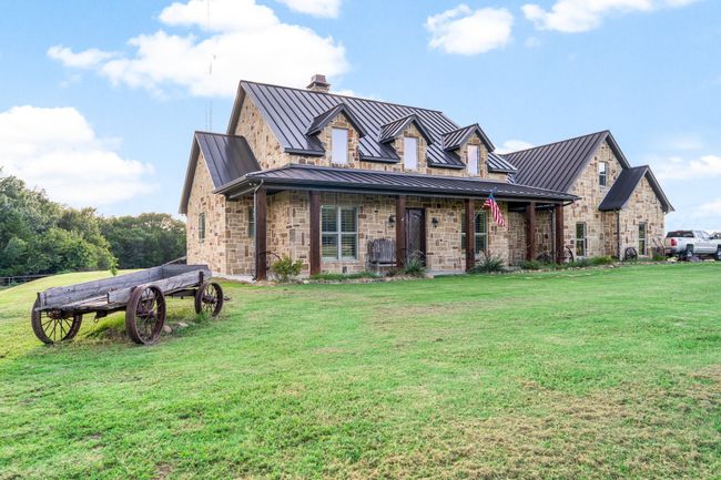 View of front of house with a standing seam roof, a front yard, and a metal roof | Image 8