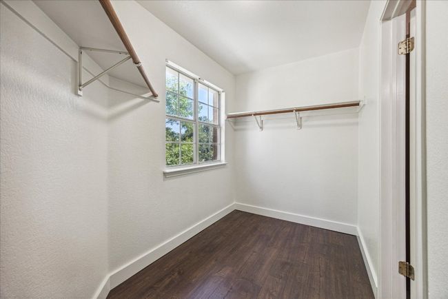 Walk in closet with dark wood-type flooring | Image 19