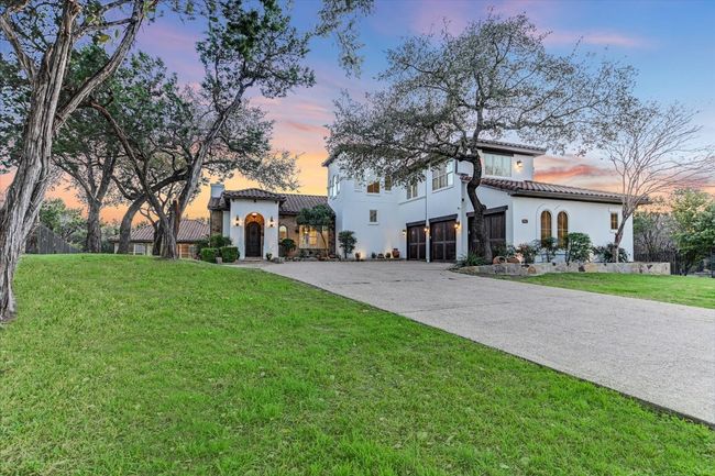 Mediterranean / spanish house featuring stucco siding, a tiled roof, curved driveway, and a front lawn | Image 4