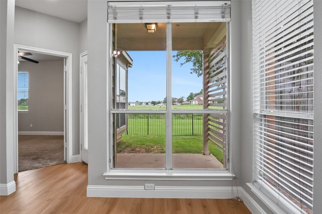 Doorway with wood finished floors and baseboards | Image 19