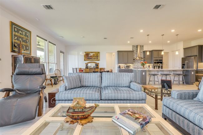 Living room featuring recessed lighting, ornamental molding, and light wood-style flooring | Image 12