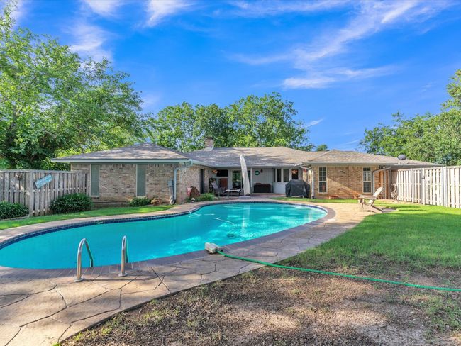 View of swimming pool with a patio | Image 33
