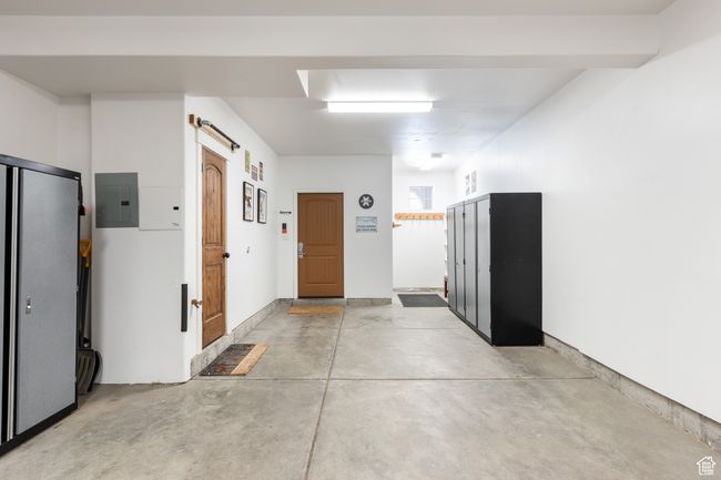 Hall with electric panel, concrete floors, and a barn door | Image 22