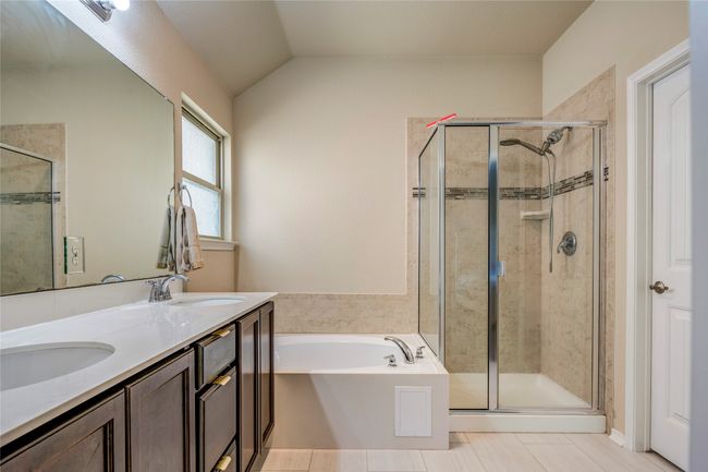 Full bath featuring a sink, a stall shower, and a garden tub | Image 28